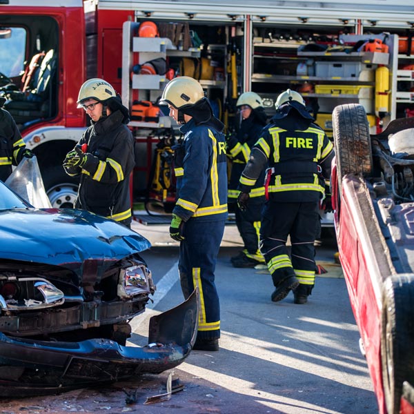car accident scene with firefighters everywhere